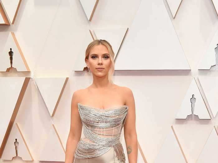 Scarlett Johansson dazzled in a silver dress that showed off her tattoos.