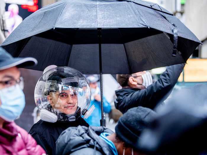 Not everyone stayed away — photos show a small number of casual spectators taking a peek at the event.