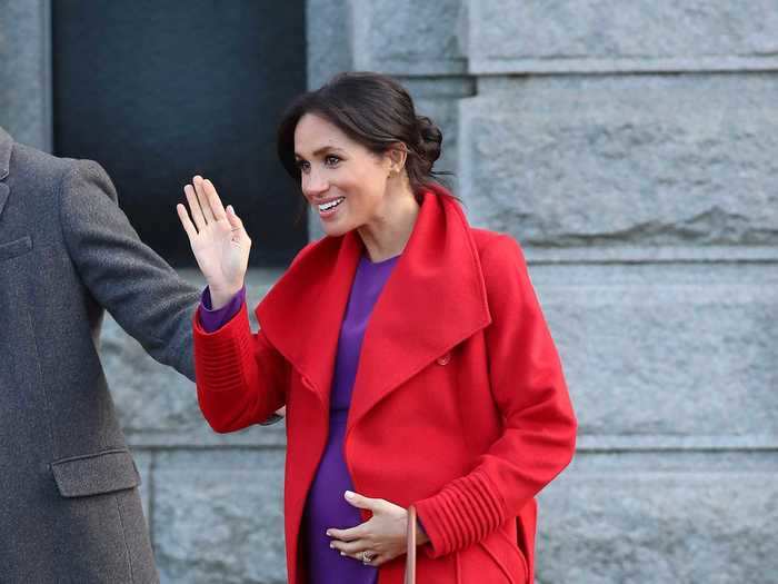 Breaking from her mostly neutral wardrobe, Meghan Markle turned heads in a bright red coat and purple dress for an event in January 2019.