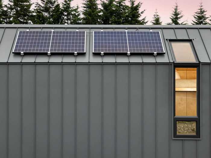 Like many well-equipped tiny homes, the roof of the DW has solar panels with batteries. For a cold day, the home on wheels also has a wood stove and electric wall heaters.