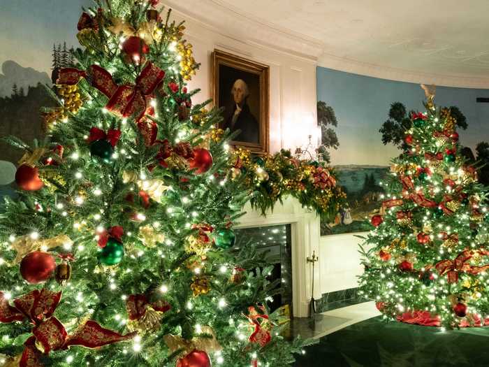 The trees in the Diplomatic Reception Room are decorated with red and gold ornaments.