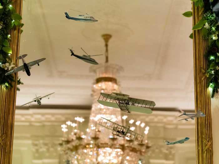 The East Room is decorated in planes, trains, and automobiles to show the US has always "been on the move." The decorations celebrate American innovations from the First Transcontinental Railroad in 1863 to the Apollo 11 moon landing in 1969.