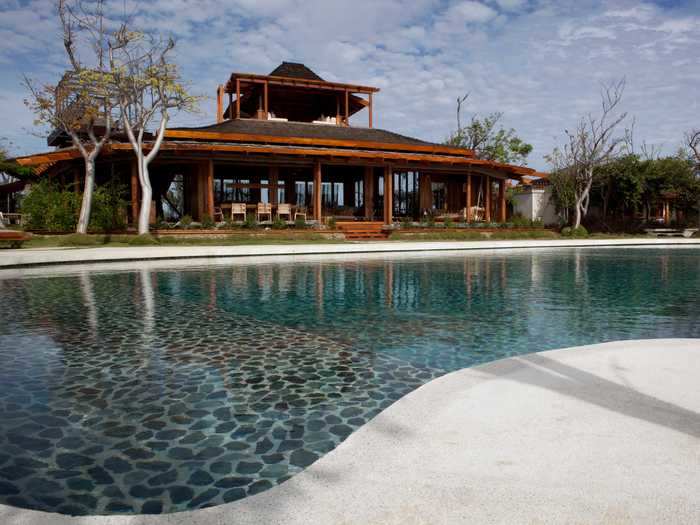 The Opium villa has safari-style decor and Bali-inspired architecture, according to its website, as well as a koi pond.