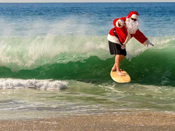 Santa rides the surf instead of a sleigh in California