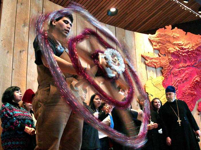 Alaskans parade a wooden star from house to house to represent the Star of Bethlehem.