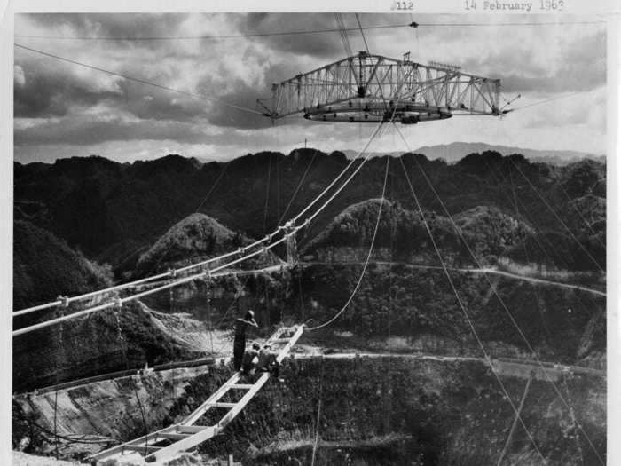 In 1963, the dish was completed with the reflection platform raised above it, supported by 18 cables connected to three towers.