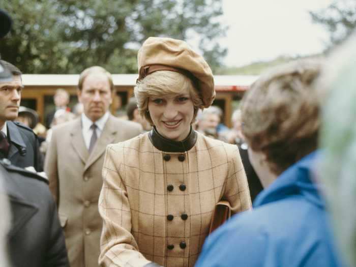 Princess Diana looked effortlessly chic in this collared, plaid Arabella Pollen coat with a matching hat.