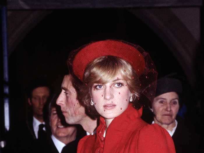 Princess Diana, age 20, wore a festive, bright red coat with a matching hat before Christmas in 1981.