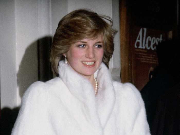 During a visit to the Royal Opera House in December 1981, Diana looked glamorous in a pure white coat, pearl jewelry, and her world-famous sapphire engagement ring.