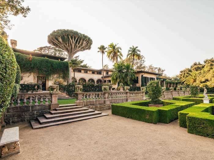 The massive space, along with manicured hedges and fencing almost look like a palace.