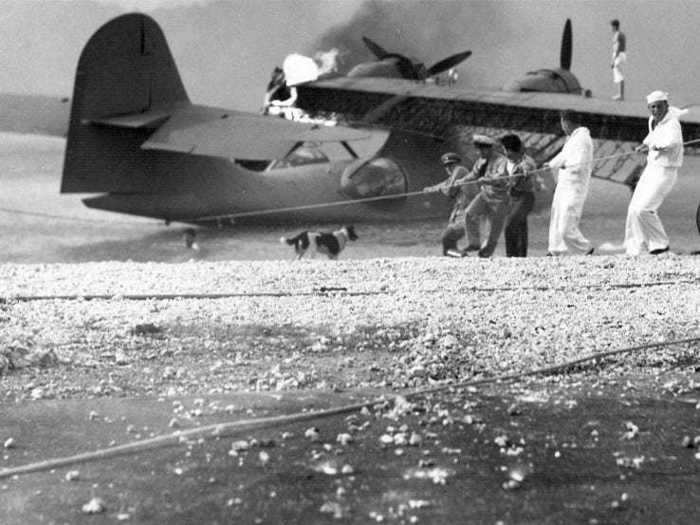 Sailors at the Naval Air Station in Kaneohe, Hawaii, attempted to salvage a burning PBY Catalina in the aftermath of the Japanese attack on Pearl Harbor.