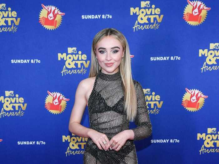 Sabrina Carpenter dazzled in a transparent, asymmetrical dress that was covered in sparkles.