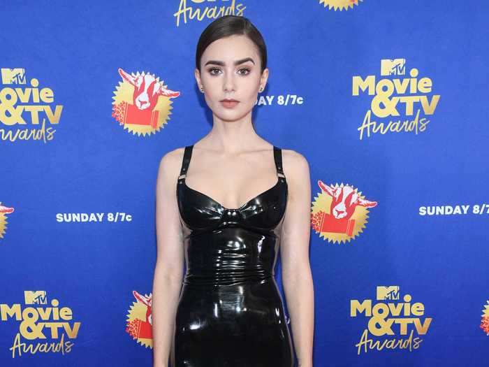 Lily Collins opted for a black gown made from latex.