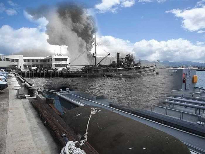 The battleship USS Arizona burns during the attack on Pearl Harbor, as seen from Ford Island.