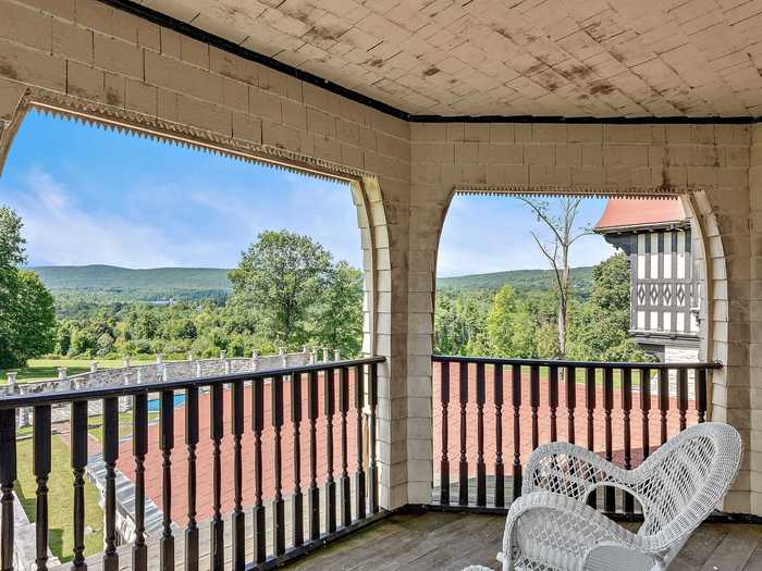 There are plenty of opportunities to take in the surrounding 89 acres on which the house sits. The main residence has multiple balconies and a porch that look out onto the lawns.