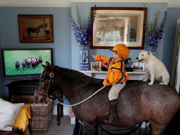 This kid brought his horse inside to watch the races.