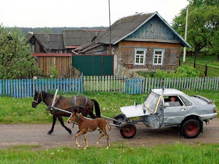 The subject matter in some photos might make you look twice. In this image of an Audi converted into a horse-drawn carriage taken in Belarus this June, shepherd Alexey Usikov sits in his car while his horses Zorka and Tulpan lead the way.