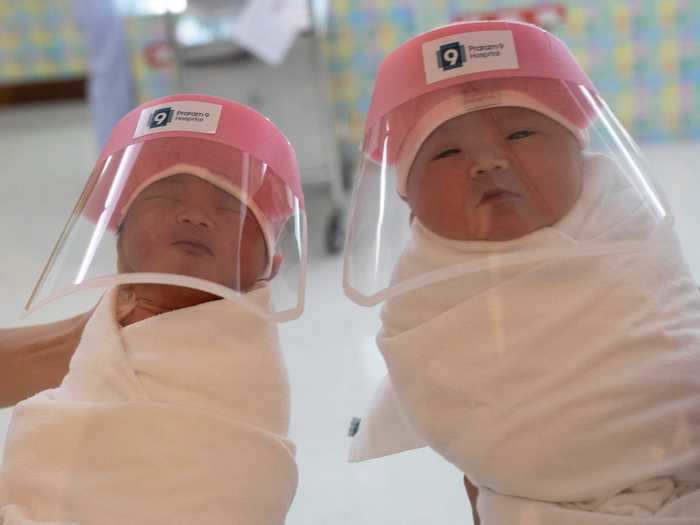 Some photos - like this image of babies in face shields - show how the pandemic has altered the world in ways that would have seemed odd a year ago.