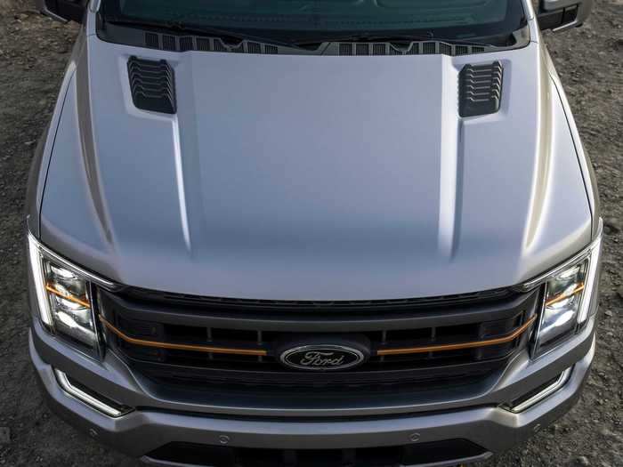 To differentiate the Tremor from other F-150 models, Ford added a redesigned hood along with orange accents on the grille, recovery hooks, and badging.