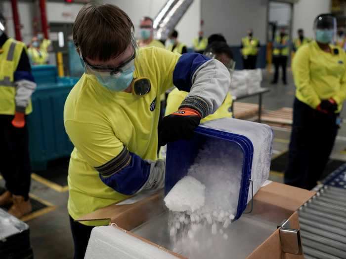 Before each box full of vaccines is sealed, workers must cover the material in dry ice. That