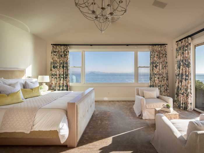 The master bedroom has direct deck access, two walk-in closets, Dual Cristallo sconces designed by Baka Studios, designer mirrors, and an attached dark-wood study.