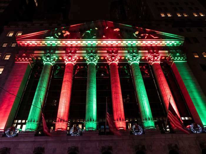 The New York Stock Exchange is lit up in red and green.