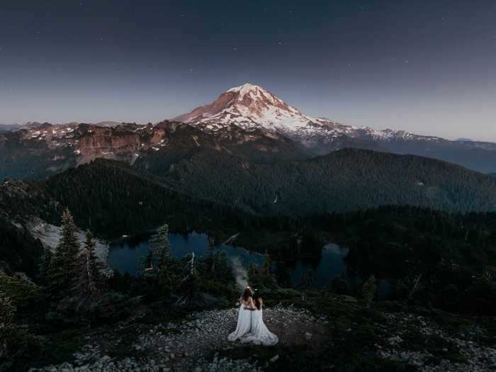 These two brides were photographed in front of Mount Rainier in Washington.