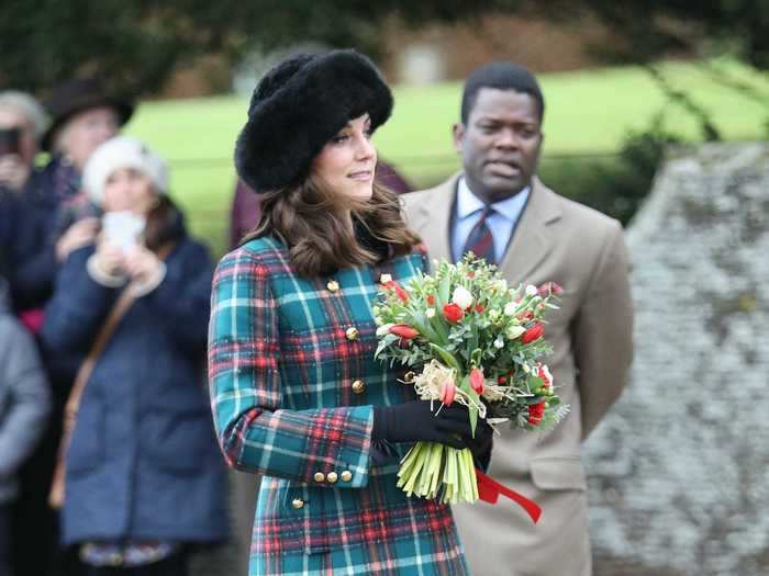 She wore a Miu Miu coat embellished with gold buttons and a black velvet collar to the royal family