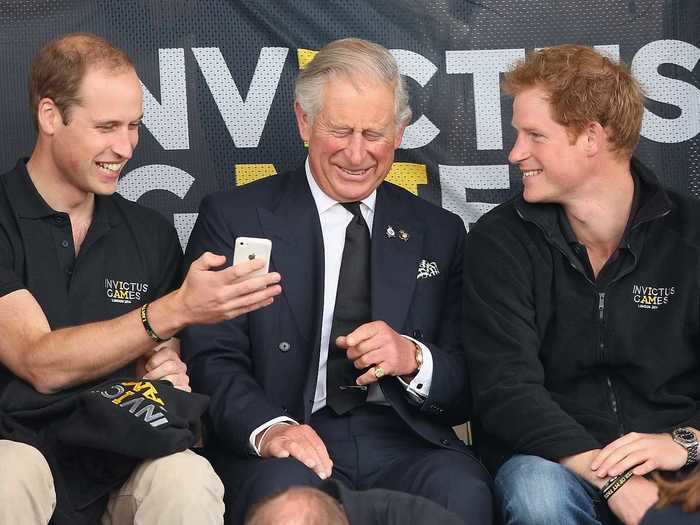 Sometimes the royals will take a break from official engagements to look at their phones. In this photo, Prince William and Prince Harry share the screen with Prince Charles at the Invictus Games in 2014.