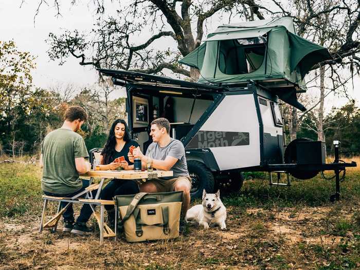 The new TigerMoth Overland also has roof rack load bars, a tongue tool box compartment, a five-pound propane tank, and an awning with mosquito nets and screen doors.