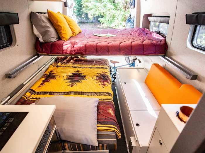 Starting with the back of the van: the new hinged bed system can sleep two with the help of dual side flares that extend the width of the van.