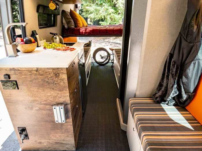 In terms of the floor plan, the shower and kitchen are at the front of the van, and the dinette and sleeping areas are towards the back.