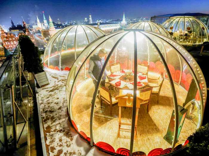 Christmas meals out are much more private this year at a Ritz-Carlton in Moscow, where guests dine in private rooftop pods.