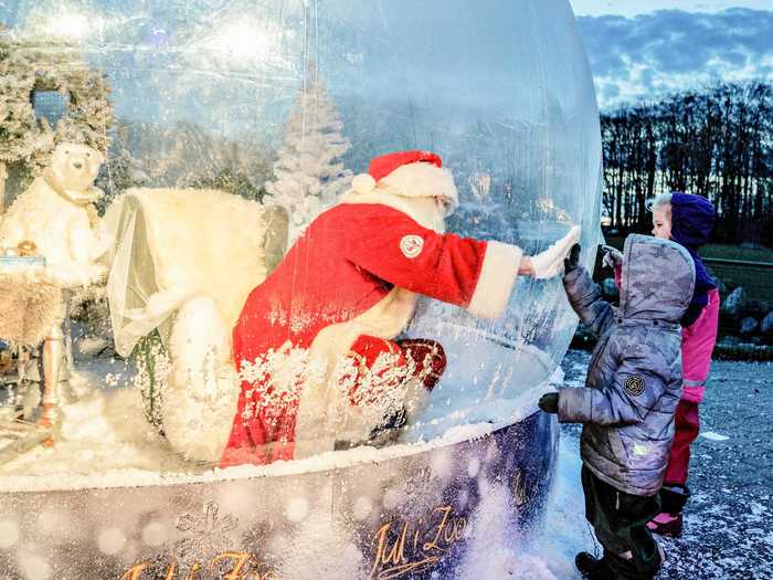 Inside or out, touching hands through the barrier seemed to replace sitting on Santa