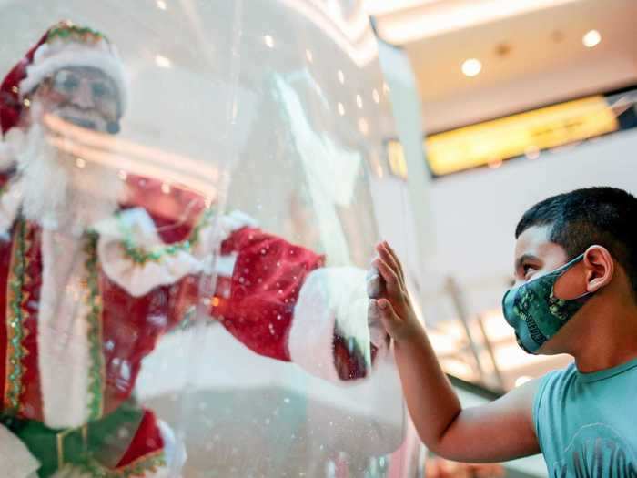 Instead, some mall Santas sat in festive plastic spheres that resemble snow globes.