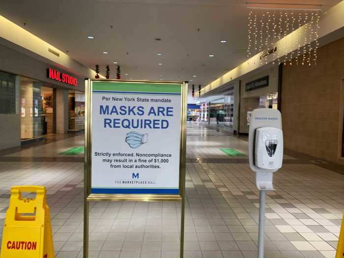 Immediately inside the entrance, more signs reflected the mask requirement along with a hand sanitizer station.