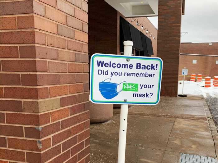 Outside of the main entrance, signs reminded people to wear masks