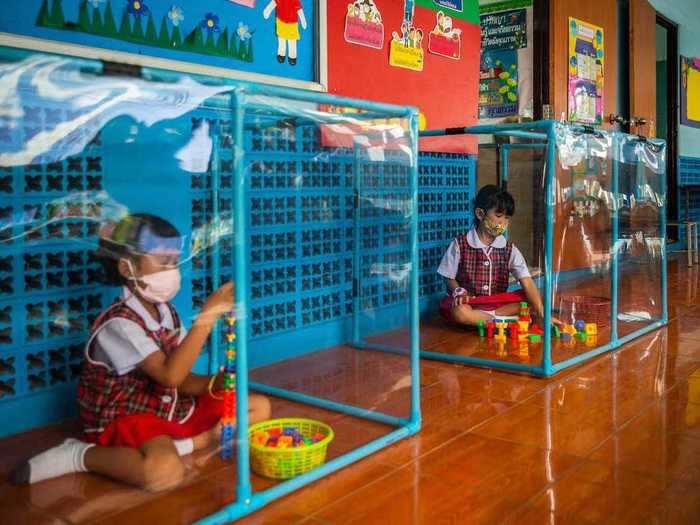 At this school in Bangkok, Thailand, students wore face masks and were separated by plastic cubes.