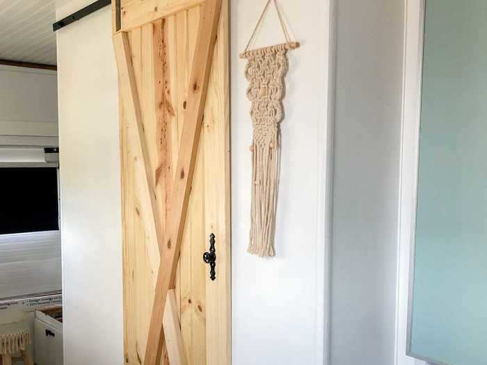 Heap and her dad built and installed a sliding door to separate the kitchen from the bathroom.