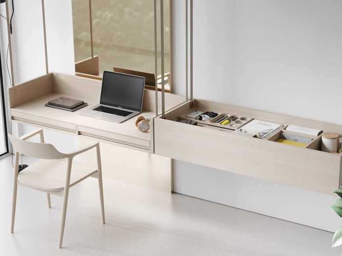 He says he is really proud of the way the desk works; it can function as a standing desk, a typical sit-down desk, or work can be left completely intact and the desk can be stowed in the ceiling.