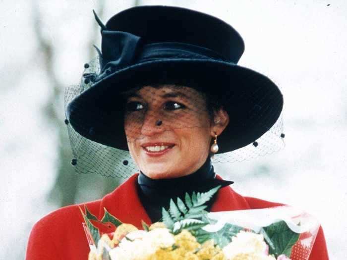 Then, in 1993, the royal wore this structured red coat with a black veiled hat.