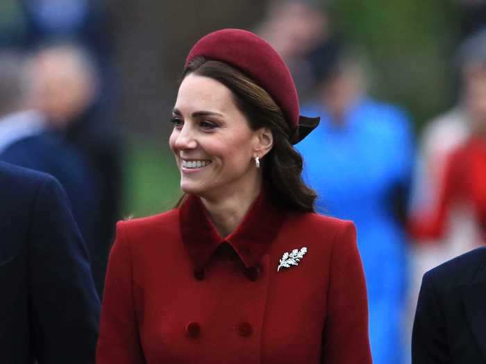 In 2018, Middleton paired a red coat with a matching hat and sparkly brooch.