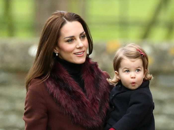 In 2016, the duchess wore a stylish, belted maroon coat with a separate faux fur collar.