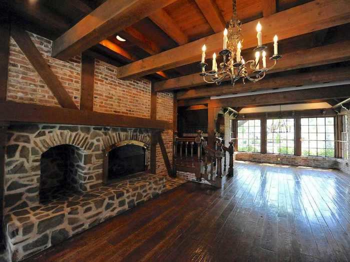 Down a few sets of stairs from the foyer is the main living room with two fireplaces.