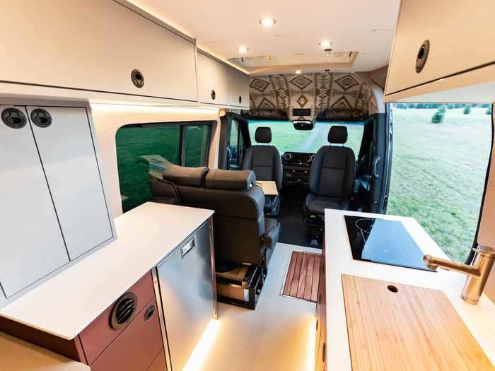 To clean off after outdoor activities, the van is equipped with an exterior shower and an interior mudroom area with a hidden pop-up shower.