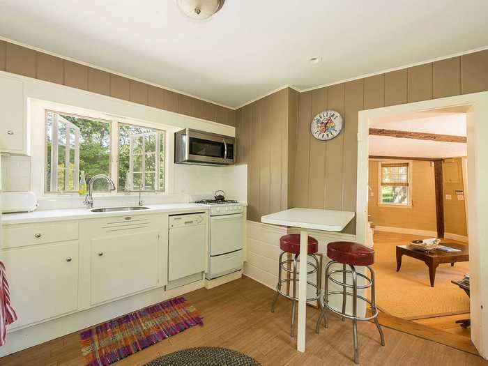 The listing describes a "country kitchen" with big windows that look out onto the lawns that surround the house.