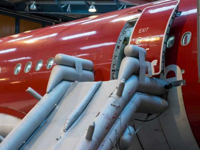 Two passengers exited their plane by using the emergency slide as it was taxiing out to leave the airport.