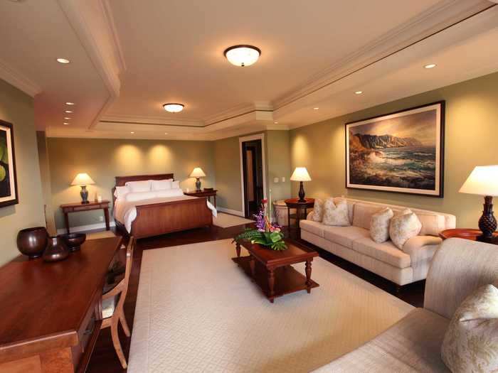 The spacious master suite includes a chaise lounge, a sofa, a writing desk, and a walk-in closet.