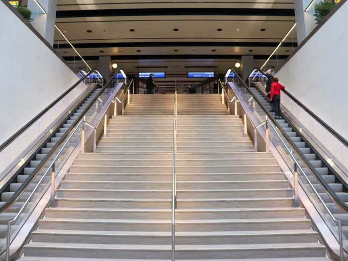 Ramps, stairs, escalators, and elevators connect the two levels, with this being the main staircase of the hall.