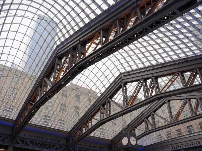 Parabolic windows above provide natural light to the hall, something Penn Station has historically lacked since moving underground.